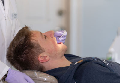 man being fitted for Invisalign clear aligners at Cochituate Smile Center